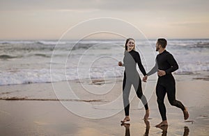 Romantic Surfers Couple Running Together Along The Beach