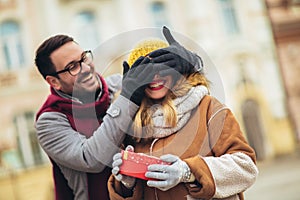 Romantic surprise for Christmas. Couple with present outdoor