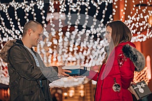 Romantic surprise for Valentine`s day  man receives a gift from her girlfriend