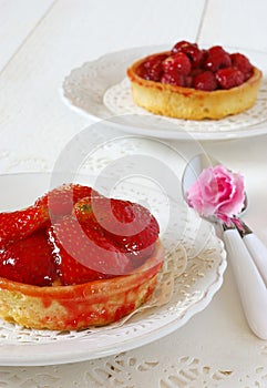 Romantic table: fruit cakes and flower azalea