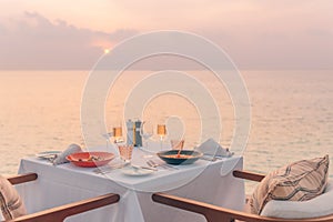 Sunset at table dinner with seascape and horizon, romance