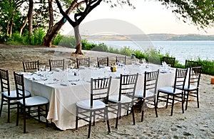 A romantic table set for dinner on the beach