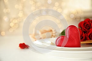 Romantic table setting against blurred lights, space for text. Valentine`s day celebration