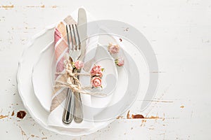 Romantic table setting with died flowers