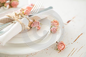 Romantic table setting with died flowers