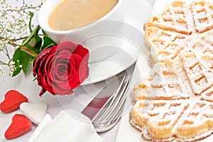 Romantic table setting with a single red rose