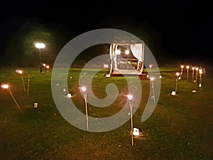 Romantic terrace with torches in a field