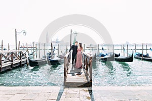 Romantic travel couple in Venice on Gondole ride romance in boat happy together on travel vacation holidays. Romantic young beauti