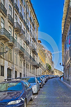 Romantic Traveling. Calm and Empty Street in Lisbon City With Lines of Cars in Portugal At Daytime