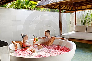 Romantic Vacation. Couple In Love Relaxing At Spa With Cocktails