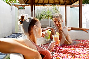 Romantic Vacation. Couple In Love Relaxing At Spa With Cocktails