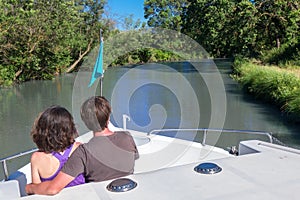 Romantic vacation, holiday travel on barge boat in canal, happy couple having fun on river cruise in houseboat