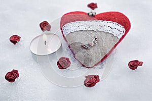 Romantic Valentine Plush Heart With A Winged Metal Heart On Ice Besides A Peaceful Tea Light Surrounded By Rose Bloom