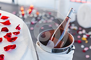 Romantic Valentine`s Day dinner setup with rose petals