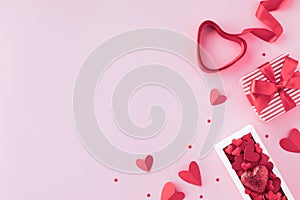 Romantic Valentines day background with gift box, red heart ribbon and various hearts. Greeting card