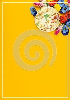 Romantic vertical concept, decorative saucer for a cup of tea, flowers, yellow isolated background, top view with border