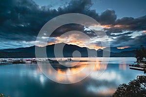 Romantic view of sunrise with crimson clouds. Beautiful lakes and mountains.