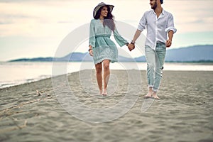 Romantic walk by the sea. Couple in love having romantic tender moments on the beach