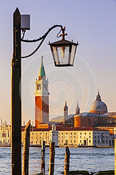 Romantic walk in Venice at sunrise with view of the basilica di Giorgio.