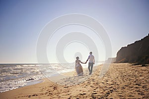 Romantic wedding couple celebrating marriage outdoors on a sea beach