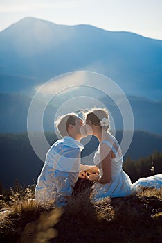 Romantic wedding couple tenderly kiss. Wonderful Alps on background