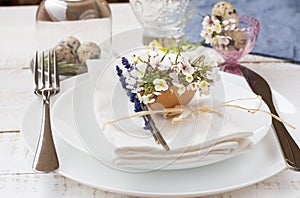 Romantic wedding or Easter table setting, lavender, white plates, flowers in eggshell