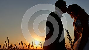 Romantic wedding kiss young couple silhouette. Loving couple at sunset nature man and girl silhouette