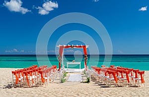 Romantic Wedding setting up with red decorations on the beach