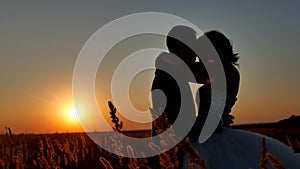 Romantic wedding young kiss couple silhouette. Loving couple at sunset nature man and girl silhouette