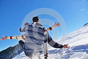 Romantic winter scene, happy young couple having fun on fresh show on winter vacatio, mountain nature landscape