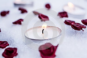 Romantic Winter Tealights On Snow Surrounded By Rose Bloom