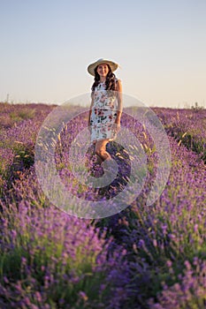 Romantic woman among blooming lavender