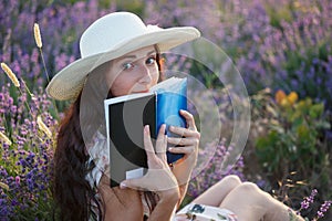 Romantic woman with book on lavender field