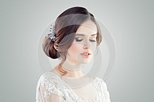 Romantic woman with bridal updo hair. Female face closeup