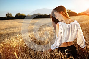 Romantic woman in fields of barley