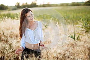 Romantic woman in fields of barley