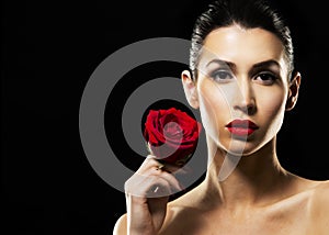 Romantic woman holding red rose on black background