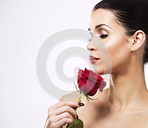 Romantic woman holding red rose on white background