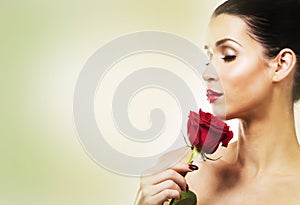 Romantic woman holding red rose on white background