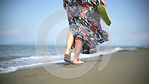 Romantic woman is walking on the beach