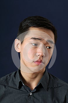 Romantic young Asian man looking sideways