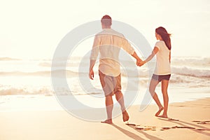 Romantic Young Couple on the Beach at Sunset