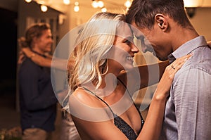 Romantic young couple dancing at party