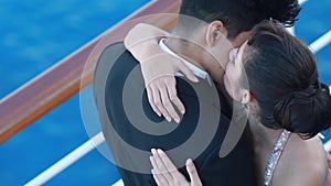 Romantic young couple enjoying ocean view from open deck on cruise ship boat. Happy lovers or bride and groom dressed