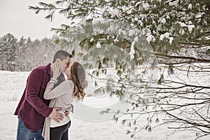 Romantic young couple kissing in winter