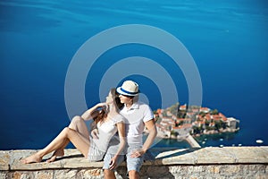 Romantic young couple in love over sea shore above Sveti Stefan