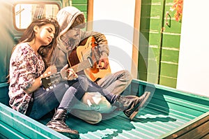 Romantic young Couple of lovers playing Guitar outdoors