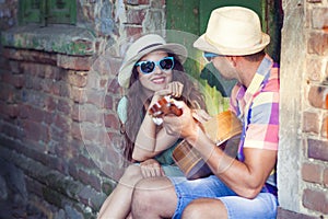 Romantic young couple playing Guitar outdoor