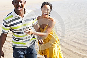 Romantic Young Couple Running Along Shoreline