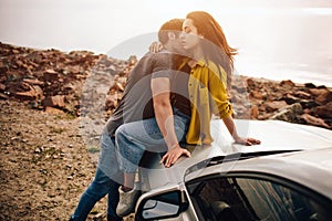 Romantic young couple sharing a special moment while outdoors. Young couple in love on a road trip. Couple embracing
